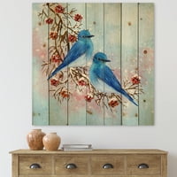 DesignArt 'Две сини птици кои седат на гранка со бобинки во зима' традиционално печатење на природно бор дрво
